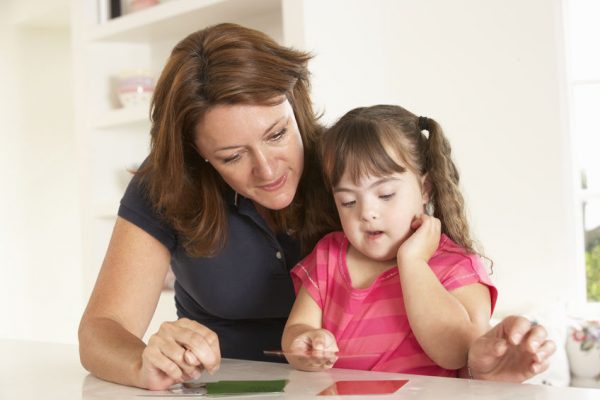 Downs Syndrome girl having speech therapy